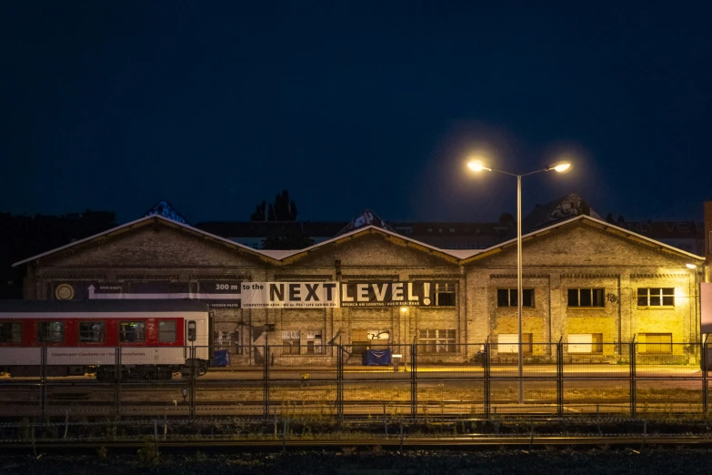 a train passes by some building at night