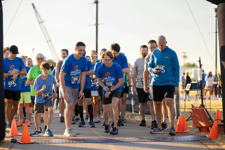 some runners walk through obstacles near an orange cone