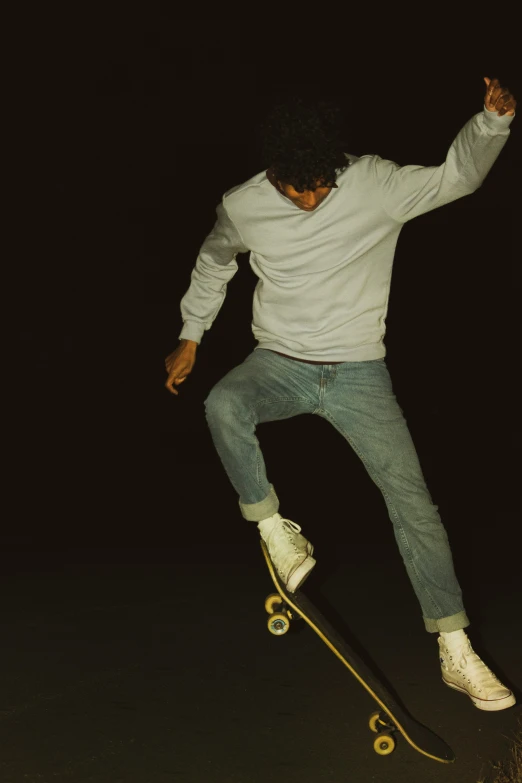 there is a man that is skateboarding at night