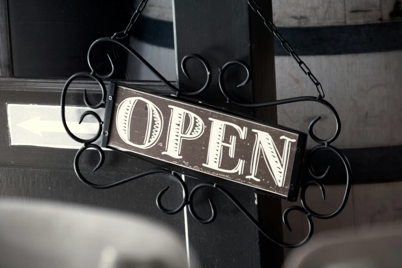 an open sign hanging from the side of a building