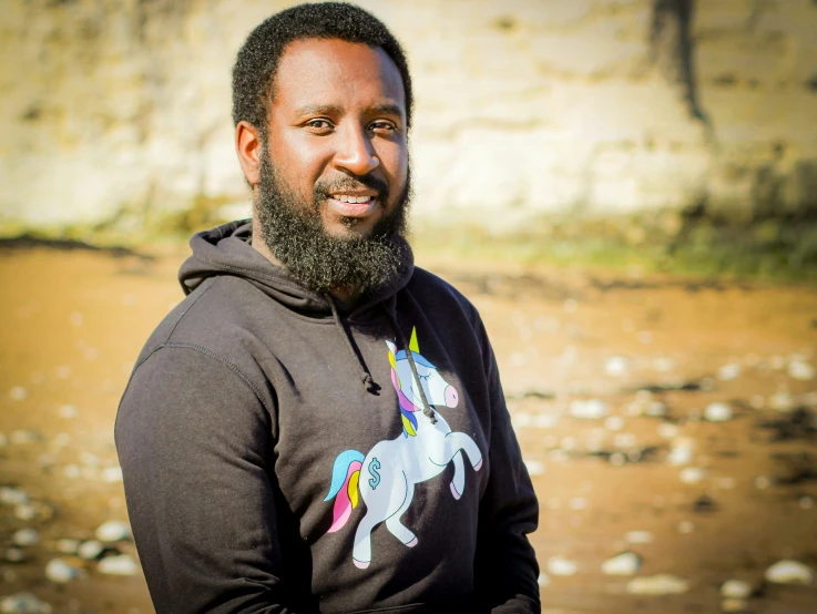 a black man with a hoodie and a horse on