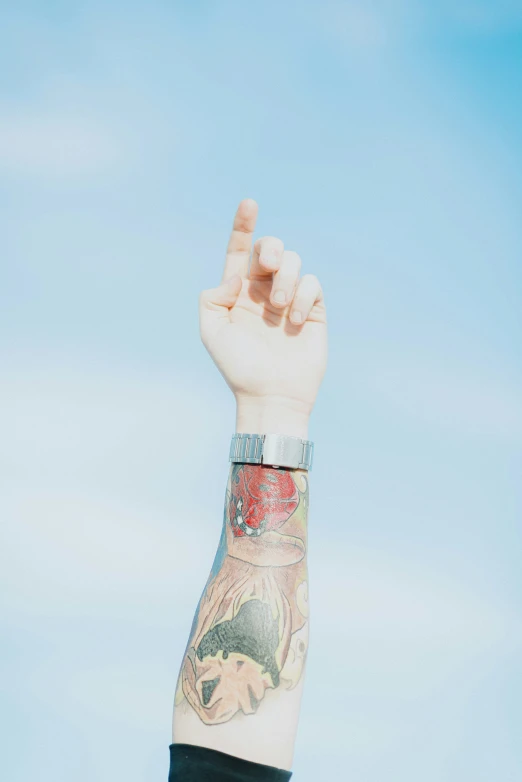 a man with a large tattoo holding up his hand
