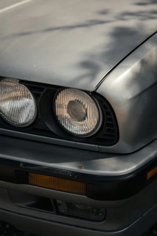 the headlights on the front bumper of a silver car