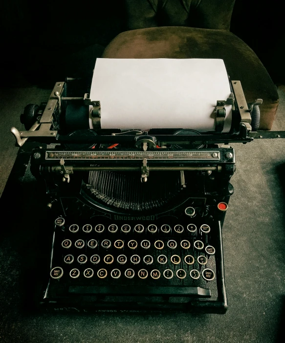 an old fashioned typewriter with a sheet of paper on it