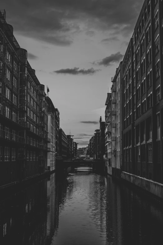 the dark is reflected in the water and many buildings