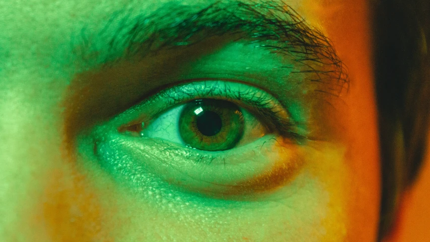 an abstract image of a mans eye with a green background