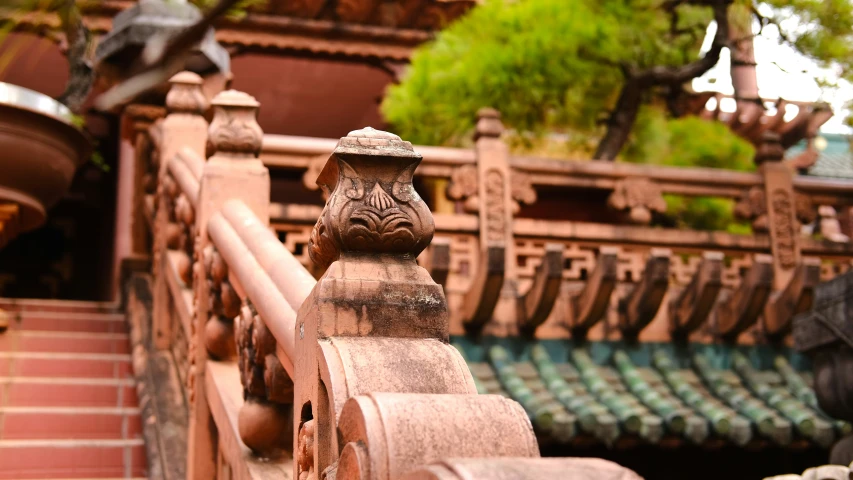 old wooden balcony railing with beautiful stone carvings