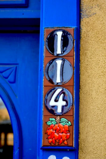 an eight - four sign is hung on the side of a blue door