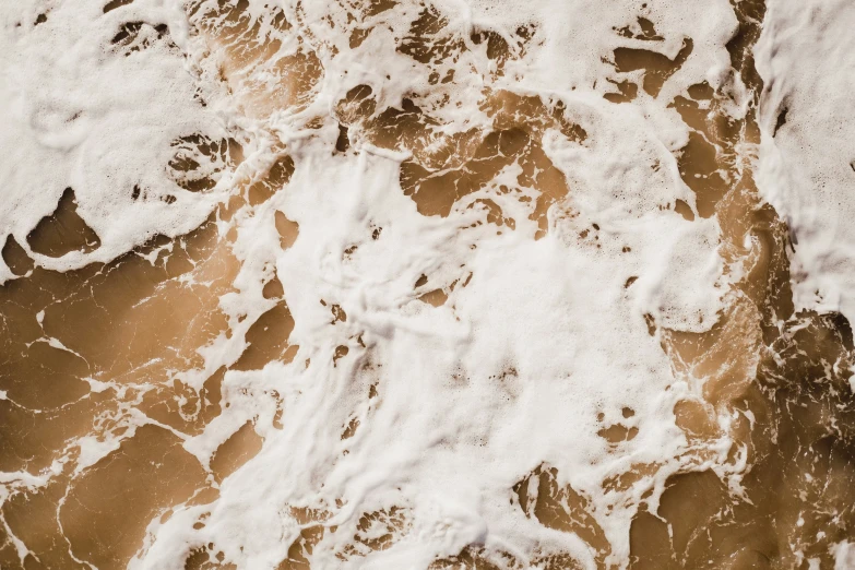 waves are crashing in to the beach near the shore