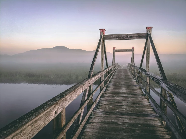 the end of a bridge on a foggy day