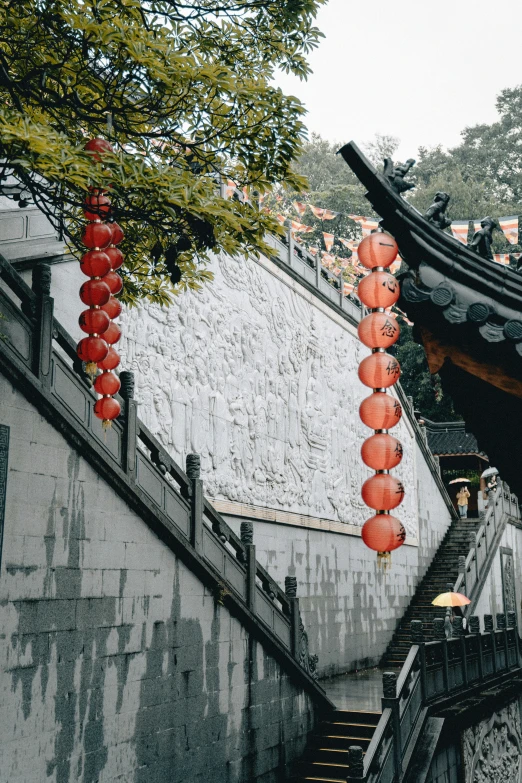 chinese lanterns hung in front of a stone staircase