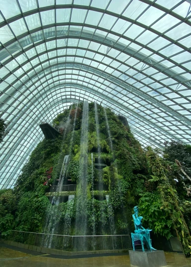 a waterfall of plants and waterfalls in a building