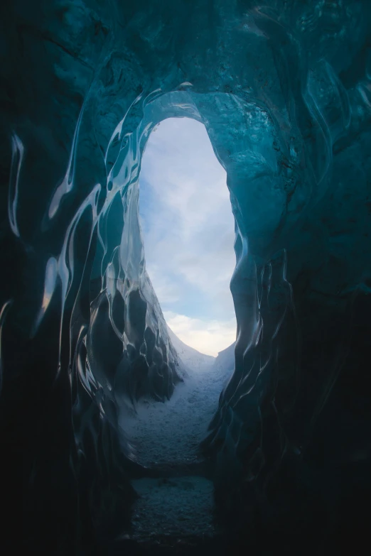 a tunnel in a mountain with ice surrounding it