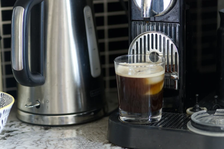 a mug filled with cold liquid and a toaster