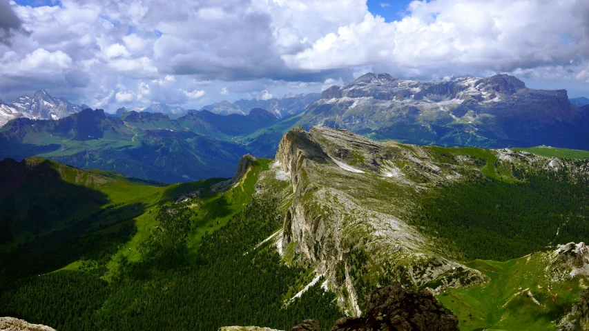 an unpaved road leads to some massive peaks in the mountains