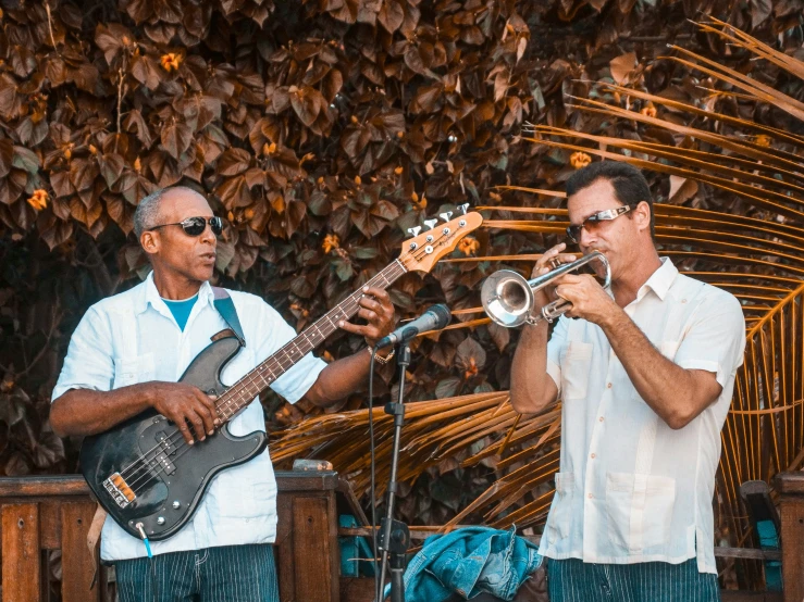 two people playing musical instruments on a stage