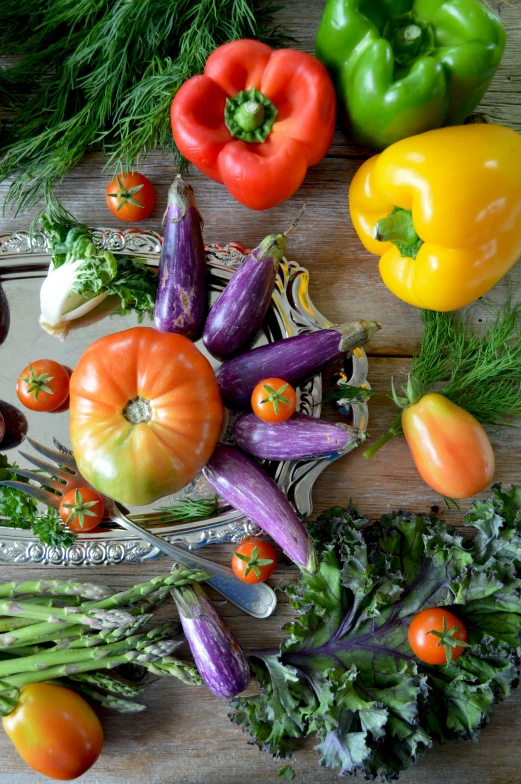 many vegetables are on a table and one on top of a knife