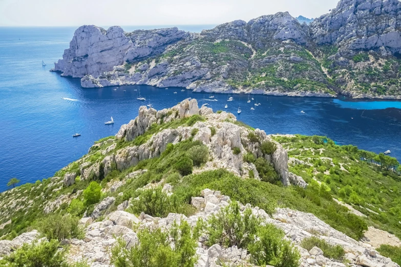 a body of water with a couple of rocky islands in the background