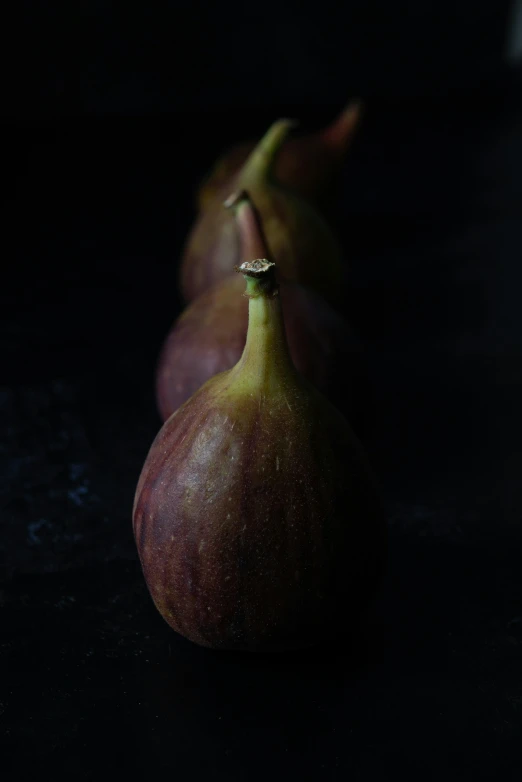 three gourds are shown in the dark on the table