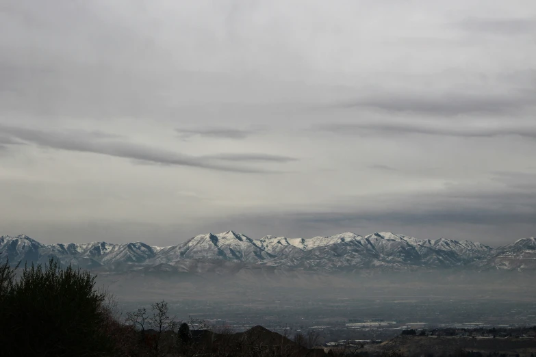 there is a snowy mountain that can be seen with a cloudy sky