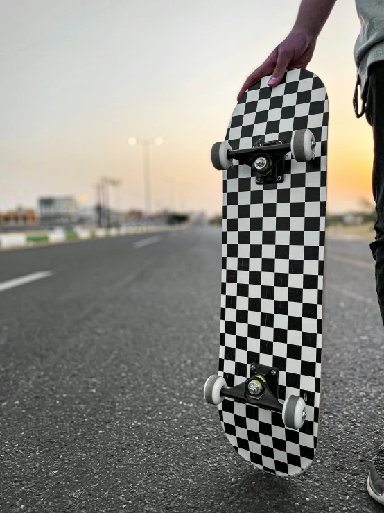 a man standing on the street with his skateboard