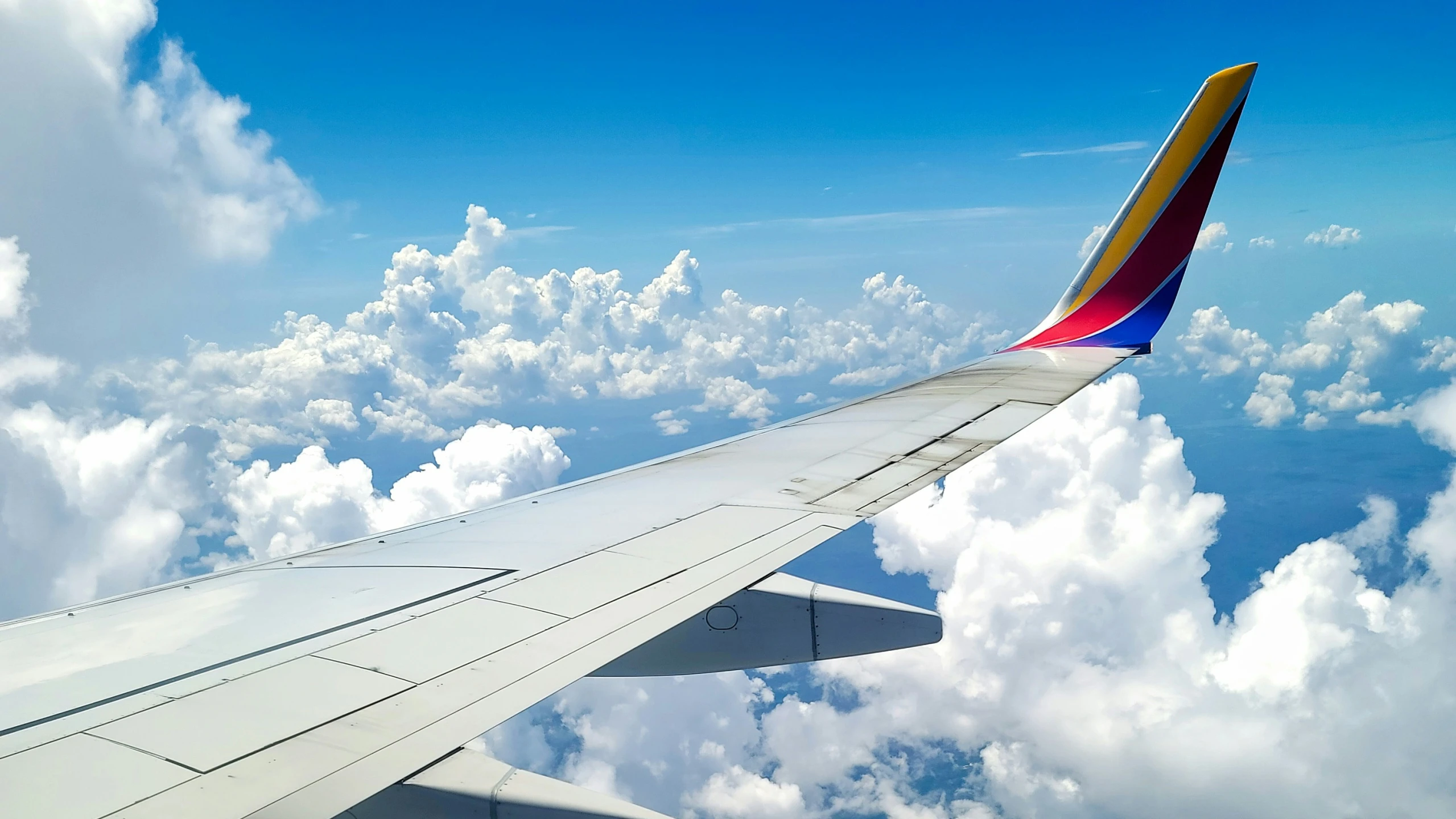 the wing of an airplane is out in the clouds