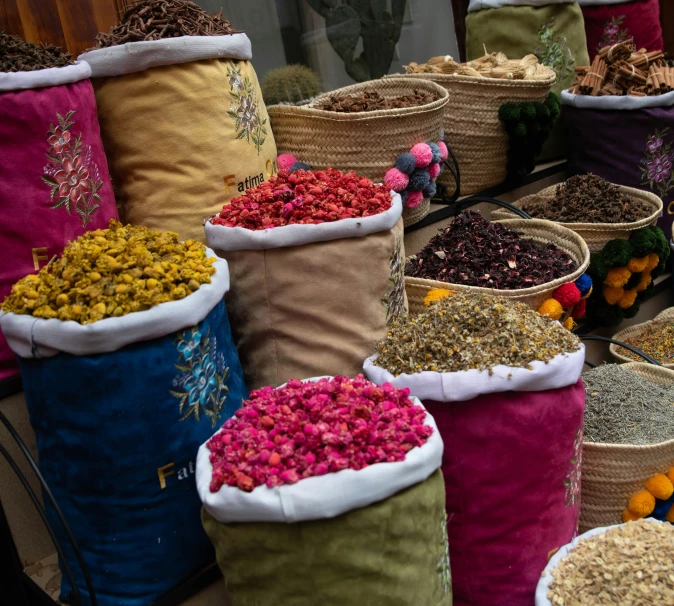 various baskets with colorful flower in them are displayed