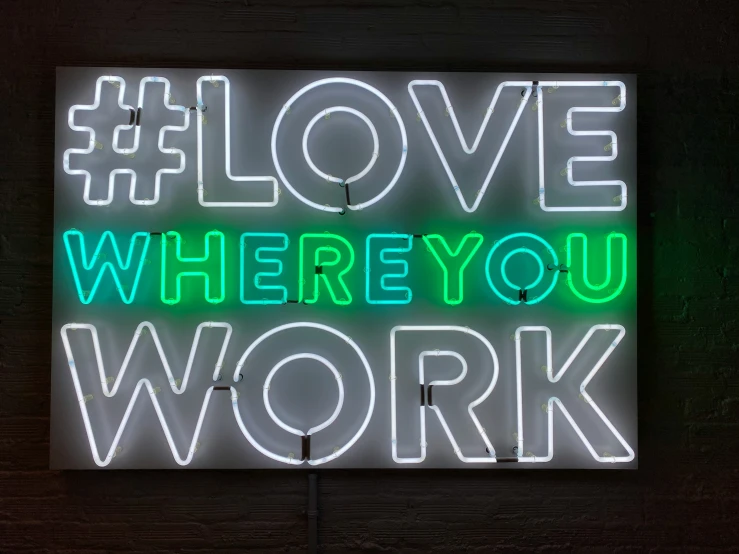neon sign reading love where you work