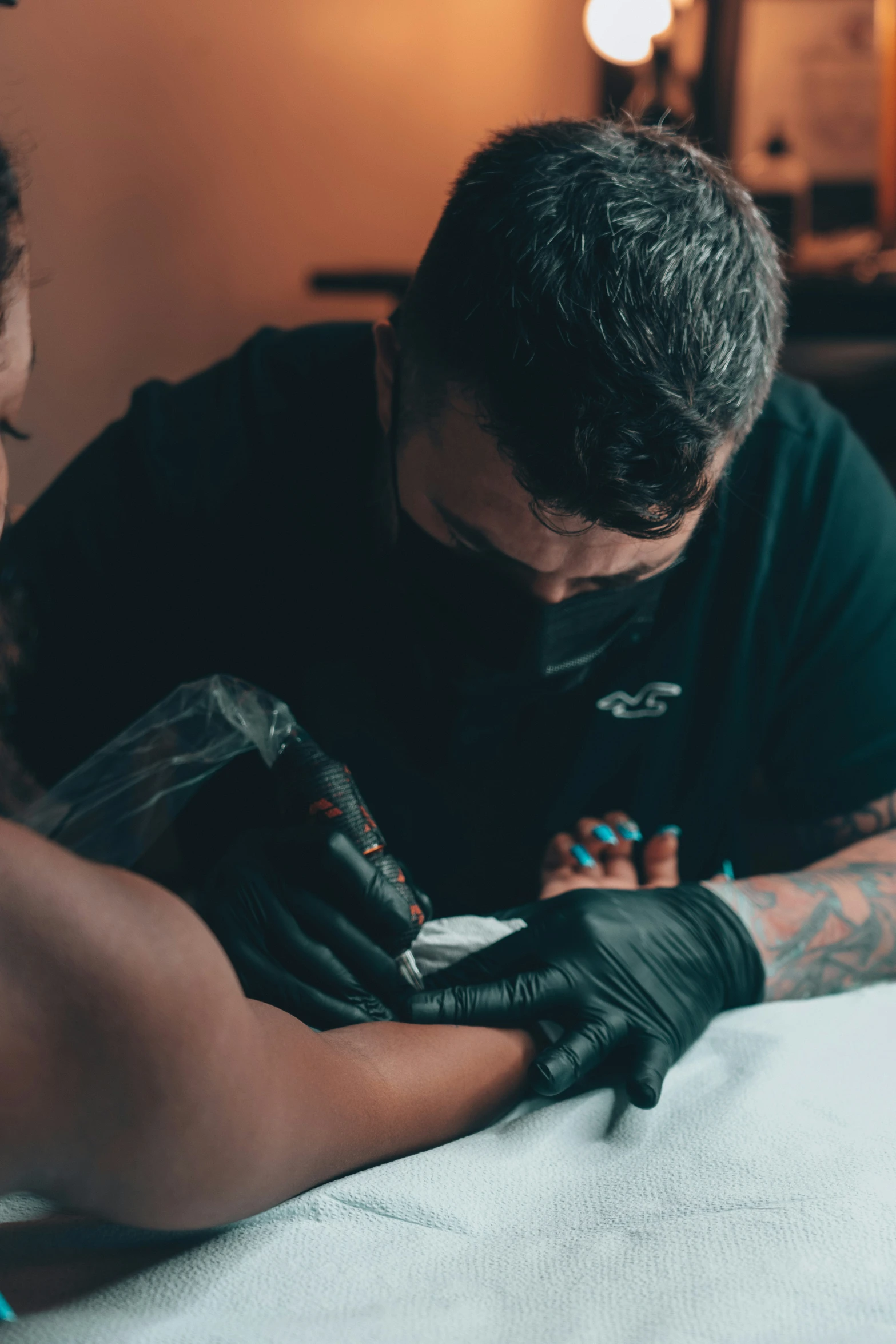 a man is getting his tattoos done by another person