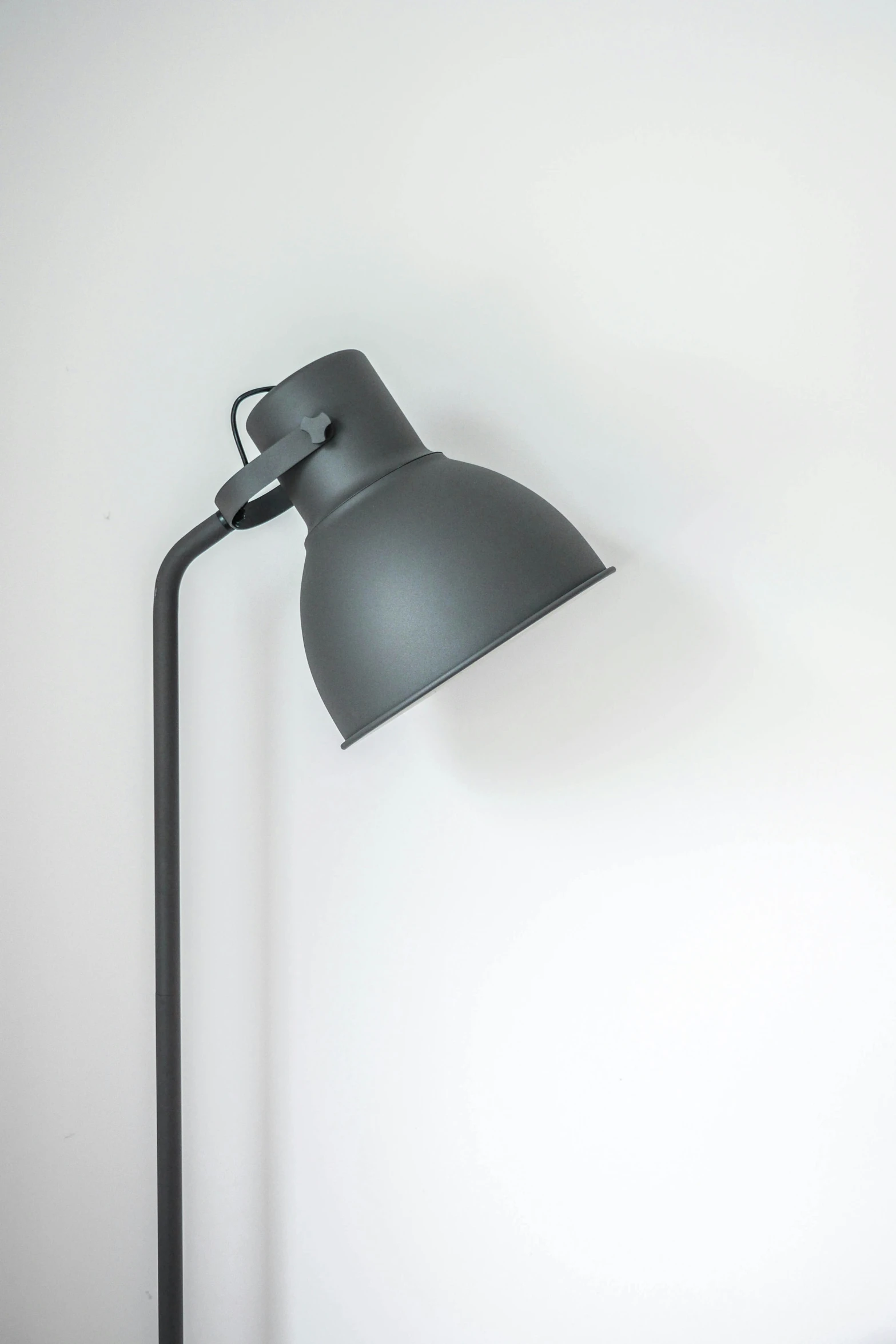 a modern black lamp is lit in the corner