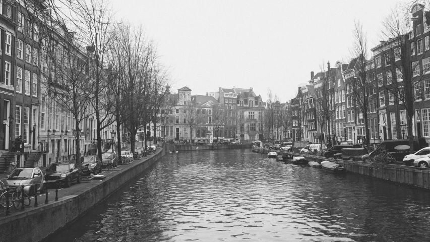 a small canal in a big city with lots of buildings