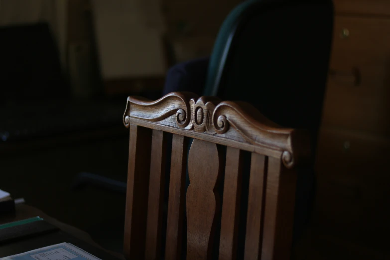 an oak chair with carving on the back and seat