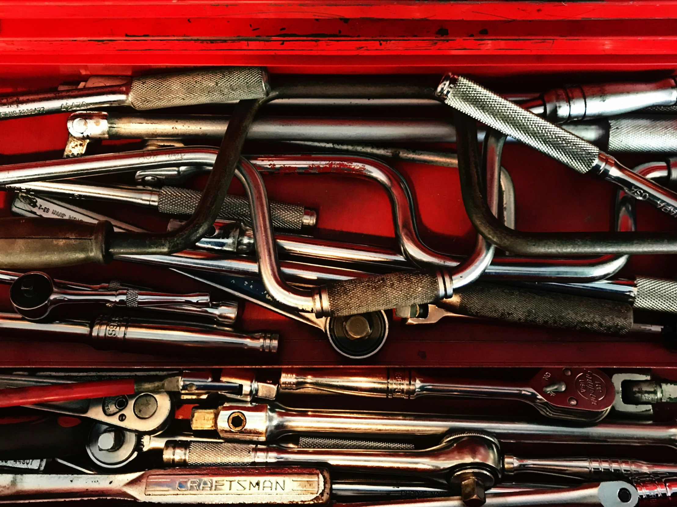 a red box is filled with different types of pipes