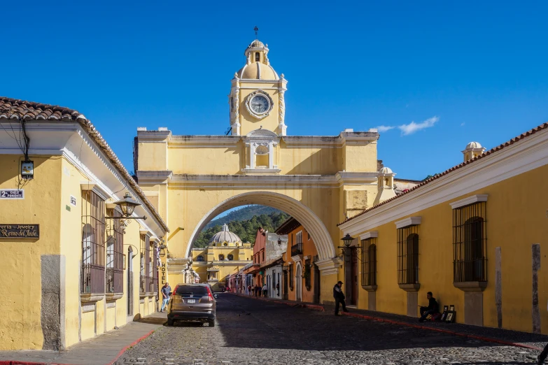 a clock tower in an old town surrounded by buildings