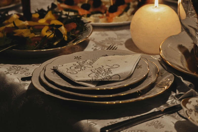 this table has plates with napkins and silverware on it