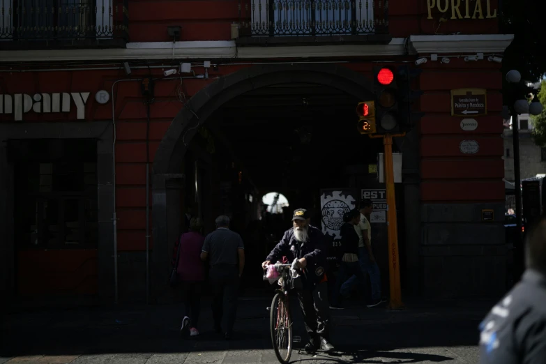 a man riding a bike near an entrance