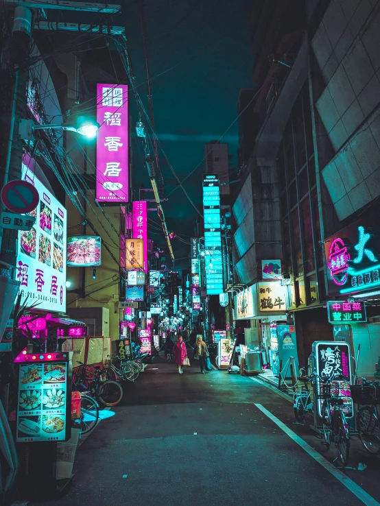 an alley way in a large city with neon signs all around