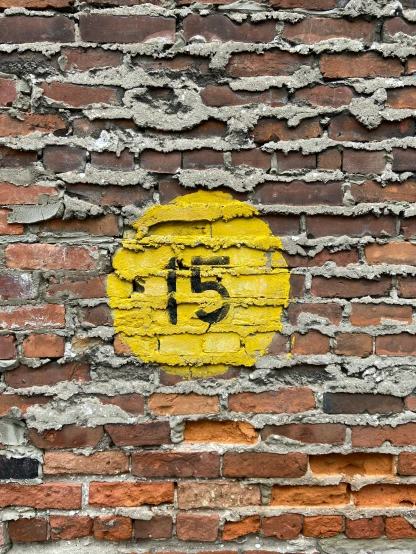 there is a painted yellow circle on the brick wall