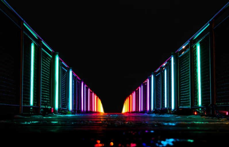 two rows of neon lit buildings sitting next to each other