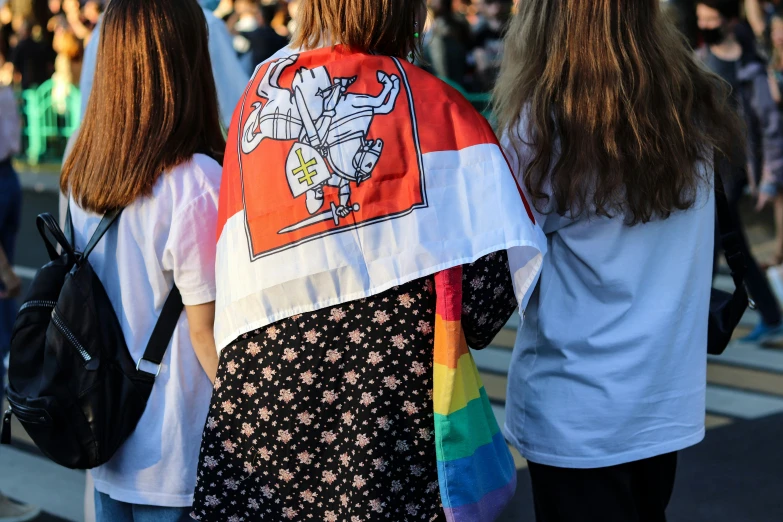 a group of young women carrying a black bag