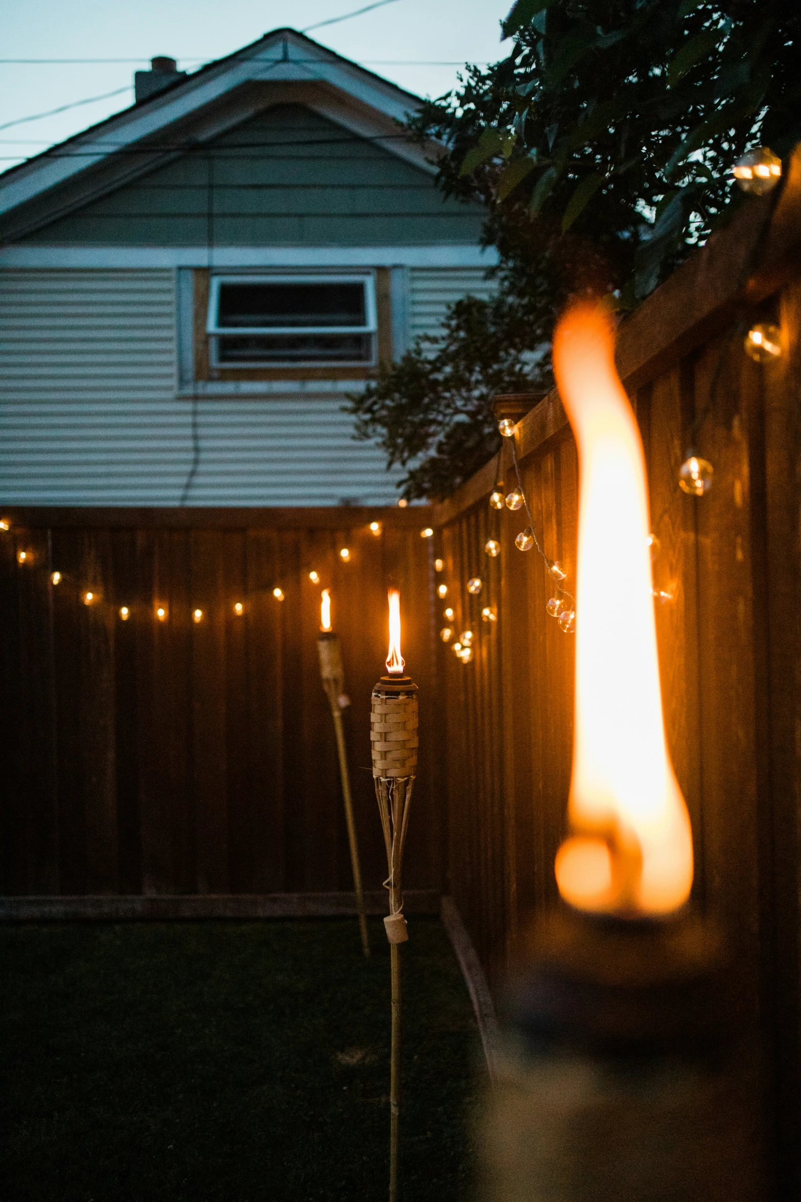 a lighted candle sits next to an iron lamp