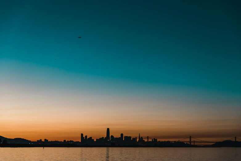 a body of water in front of a cityscape