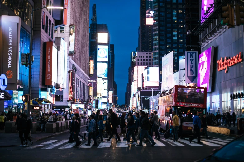 many people are walking in the busy city