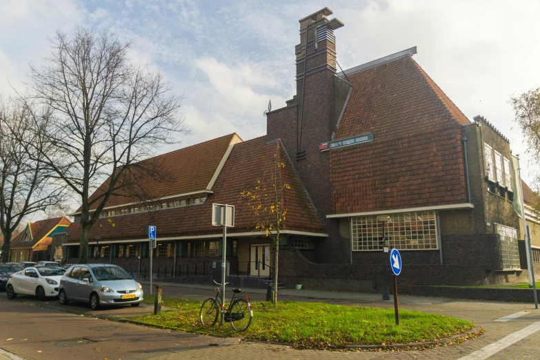 this old building has many cars parked on it