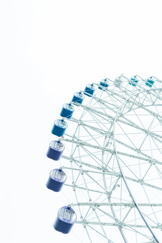 the ferris wheel in a white sky with many blue objects