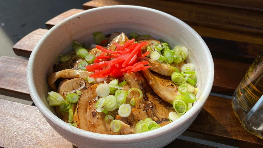 the bowl contains some vegetables in it and a drink