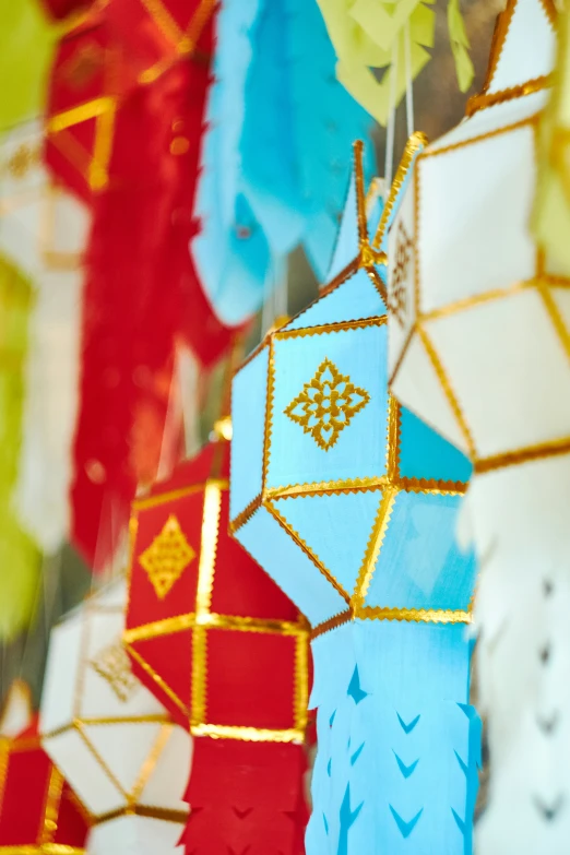 a variety of paper decorations hanging from strings