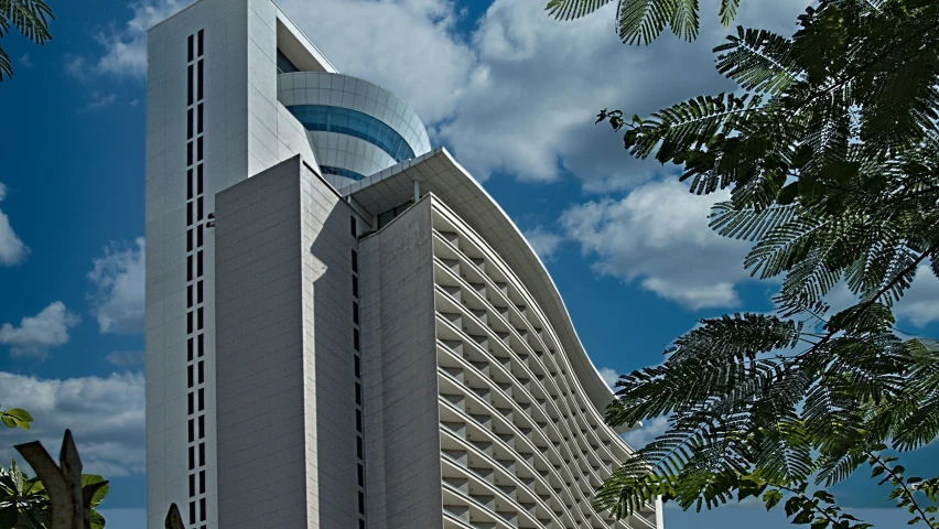 a tall white building with a domed design