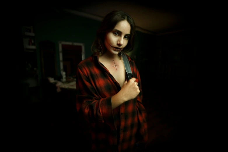 a girl wearing a plaid robe holding a knife