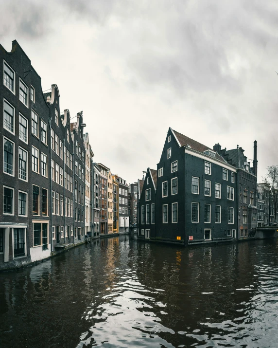 a waterway with houses near the water on a cloudy day